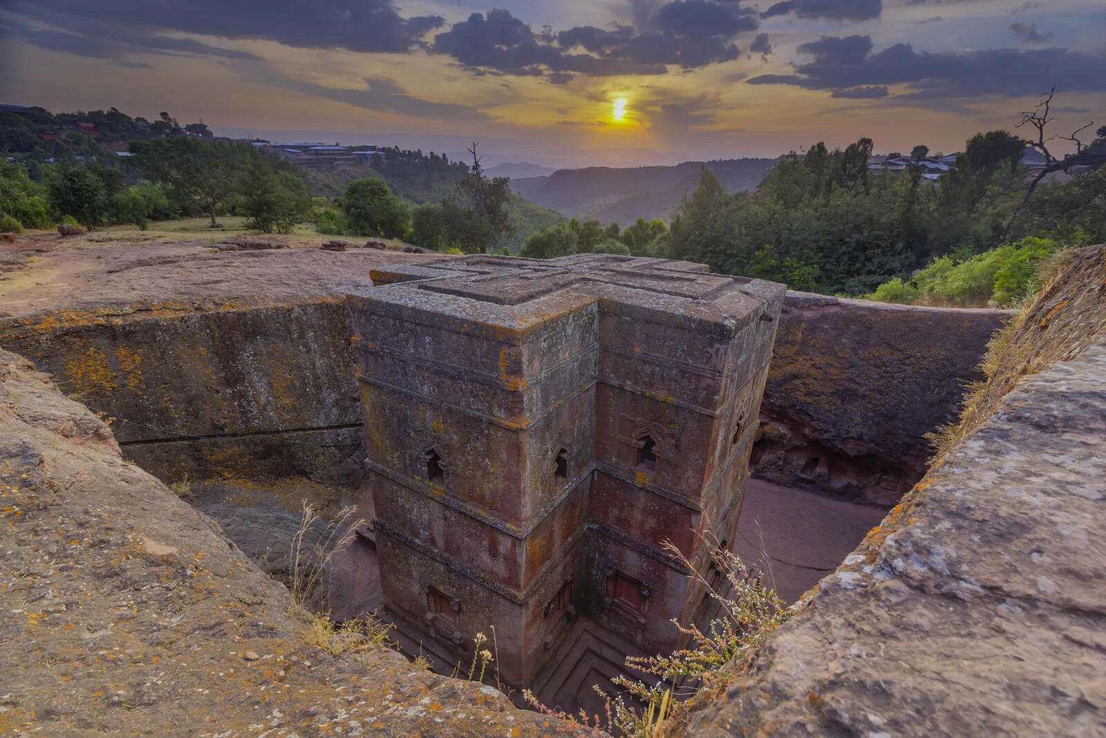 Church of Saint George (Bete Giyorgis) in Lalibela, Ethiopia — a cross-shaped church carved 40 feet down into solid volcanic rock. Photograph at sunset.